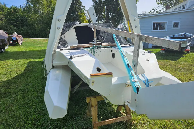 Slide: The Image of 2007 Scarab 22 sailboat on grass, with trees and a house in the background. - 7