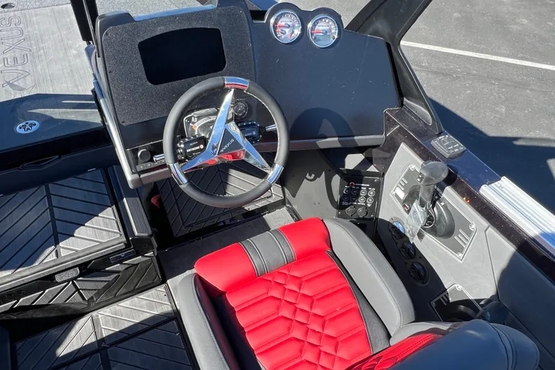 Slide: The Image of 2026 Vexus DVX20S boat interior with red and black seating, modern steering wheel, and dashboard controls. - 17