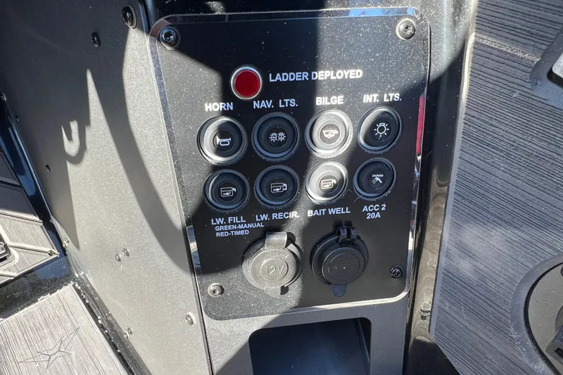 Slide: The Image of Control panel of 2026 Vexus DVX20S boat with various switches and ports. - 19