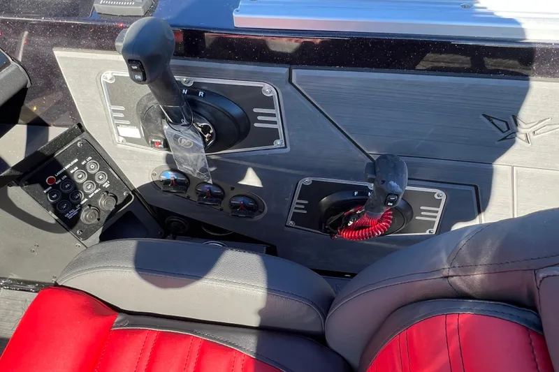 Slide: The Image of Control panel of 2026 Vexus DVX20S boat with red and black seating. - 20