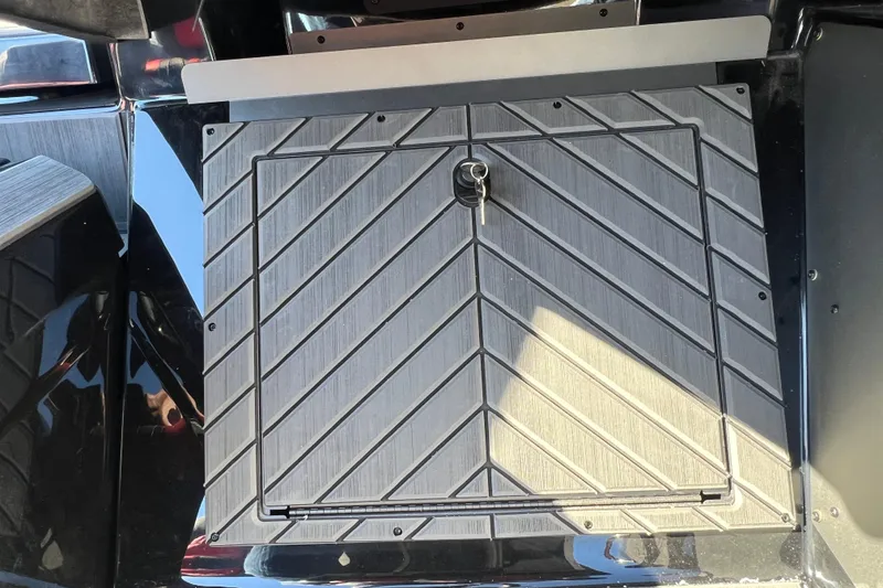 Slide: The Image of 2026 Vexus DVX20S boat storage compartment with key lock, featuring a sleek, textured design. - 24