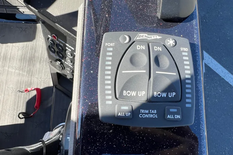 Slide: The Image of Control panel of 2026 Vexus DVX20S boat with trim tab controls. - 26