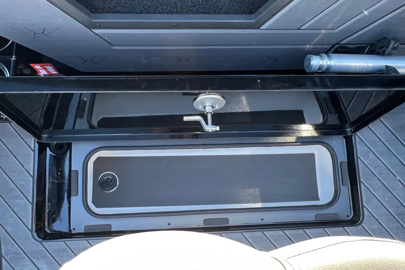 Slide: The Image of 2026 Vexus DVX20S boat storage compartment with open lid and handle. - 32