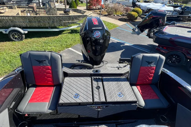 Slide: The Image of 2026 Vexus DVX20S boat interior with red and black seating, Mercury engine visible. - 36