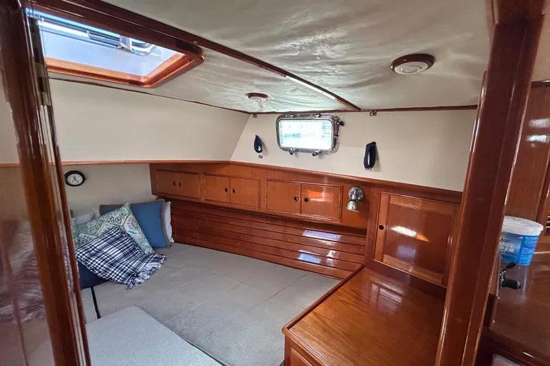 Slide: The Image of Cozy cabin interior of 1999 Eastbay 38 yacht with wooden furnishings and porthole window. - 13