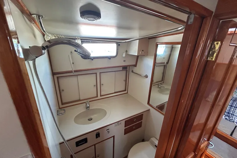 Slide: The Image of Luxurious 1999 Eastbay 38 yacht bathroom with wooden accents and modern fixtures. - 14