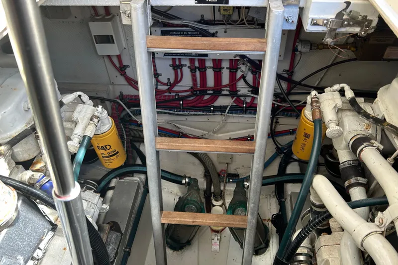 Slide: The Image of Engine room of a 1999 Eastbay 38 boat with visible machinery and wiring. - 16