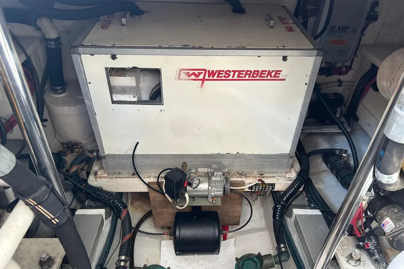 Slide: The Image of Engine room of a 1999 Eastbay 38 featuring a Westerbeke generator. - 17
