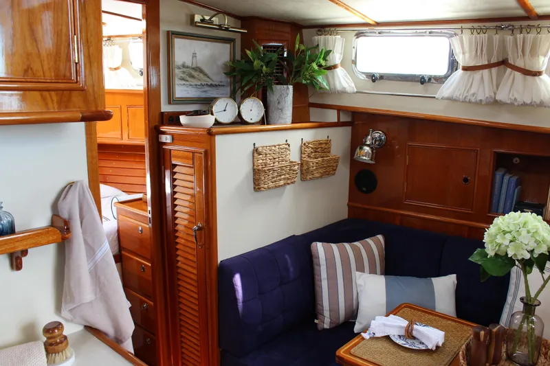 Slide: The Image of Interior of 1999 Grand Banks 38 Eastbay HX yacht with cozy seating and nautical decor. - 20