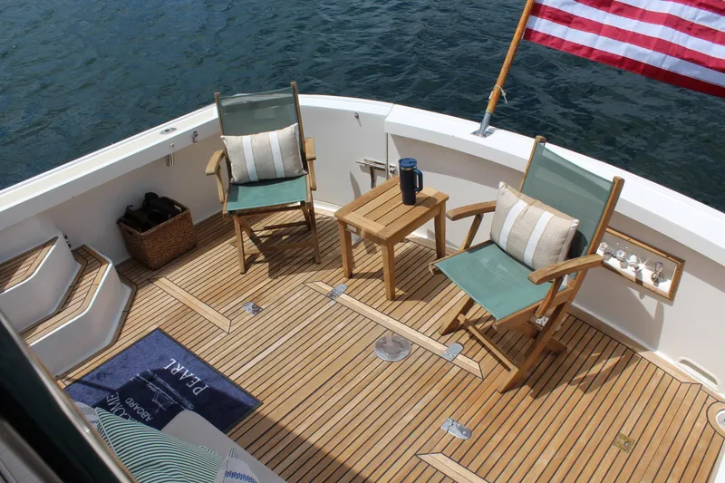 Slide: The Image of Teak deck of 1999 Grand Banks 38 Eastbay HX with chairs and table, overlooking water. - 21