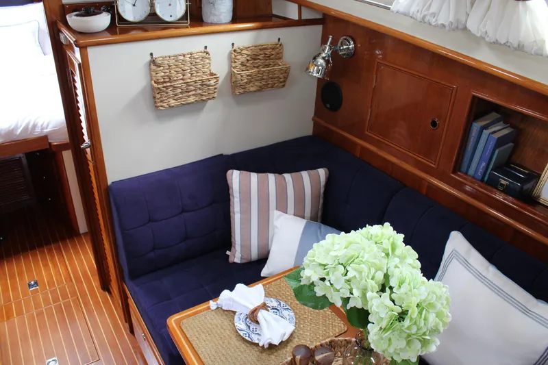 Slide: The Image of Interior of 1999 Grand Banks 38 Eastbay HX with cozy seating and elegant decor. - 24
