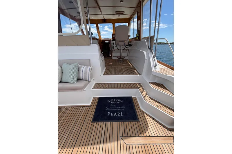 Slide: The Image of Interior view of 1999 Grand Banks 38 Eastbay HX yacht with welcome mat and seating. - 27