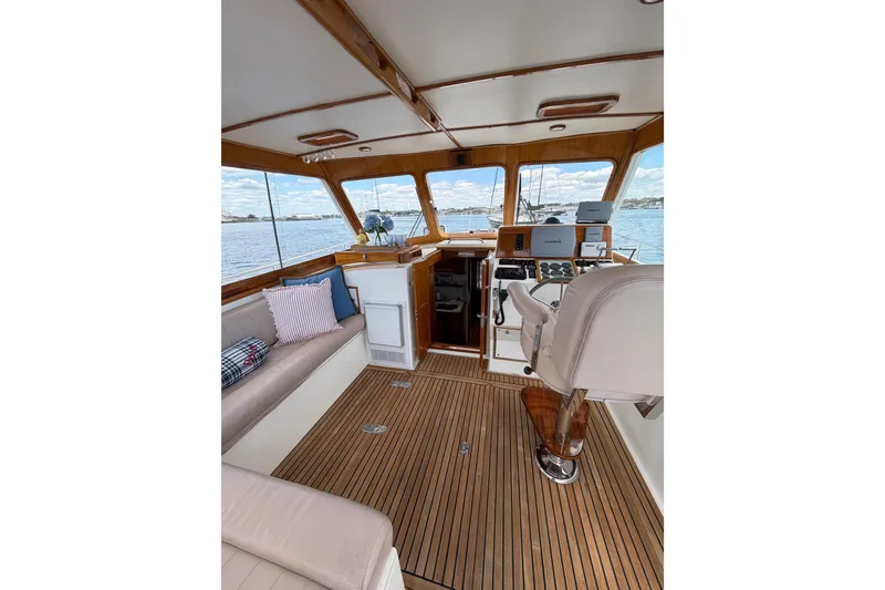 Slide: The Image of Interior of 1999 Grand Banks 38 Eastbay HX yacht with wooden flooring and plush seating. - 30