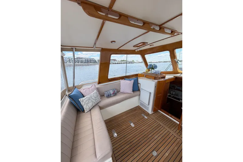 Slide: The Image of Interior of 1999 Grand Banks 38 Eastbay HX yacht with elegant seating and scenic water view. - 31