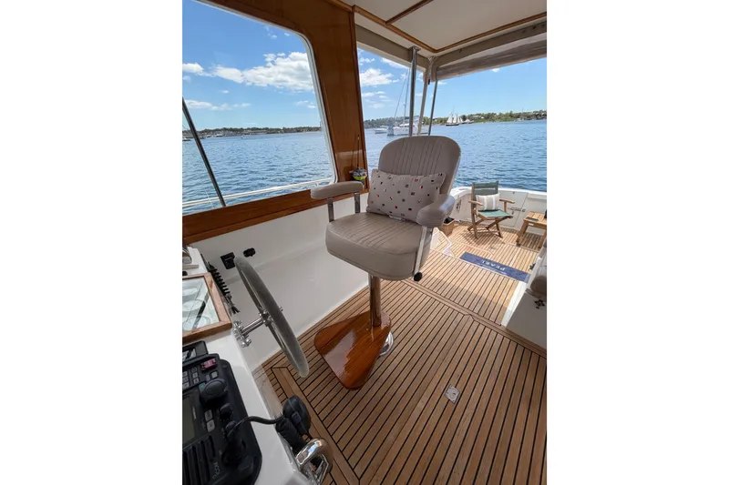 Slide: The Image of Helm seat on 1999 Grand Banks 38 Eastbay HX yacht with scenic ocean view. - 33