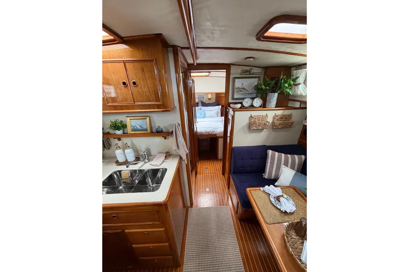Slide: The Image of Interior of 1999 Grand Banks 38 Eastbay HX yacht with cozy seating and elegant wood finishes. - 35