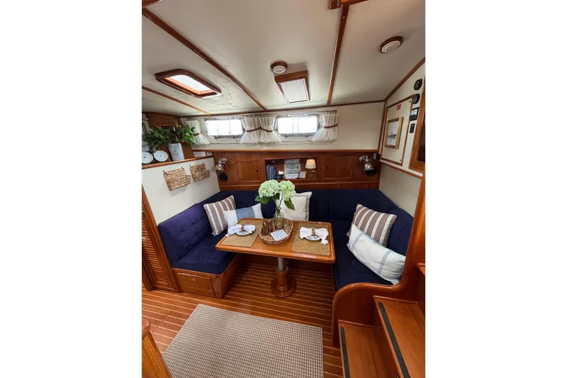 Slide: The Image of Cozy interior of 1999 Grand Banks 38 Eastbay HX with elegant wood finish and plush seating. - 38