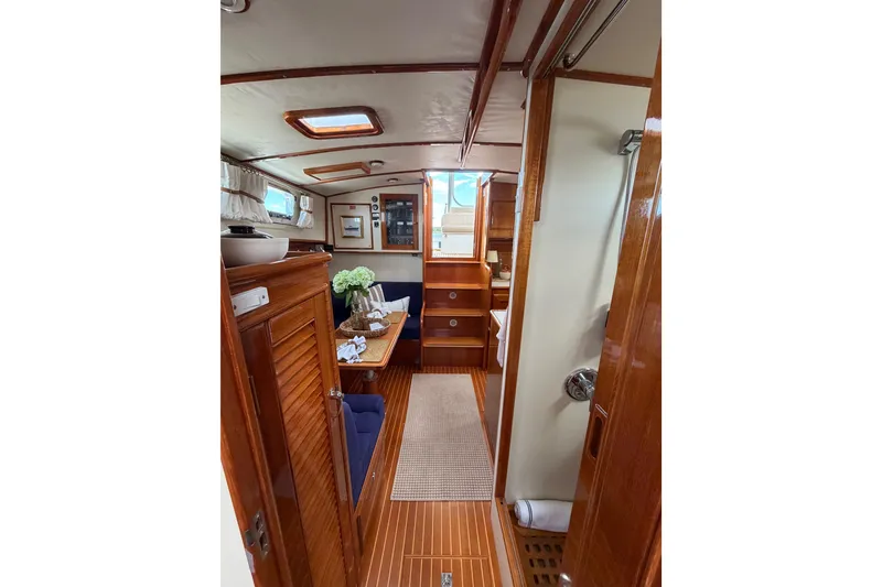 Slide: The Image of Interior of 1999 Grand Banks 38 Eastbay HX yacht with wooden finishes and cozy seating area. - 39