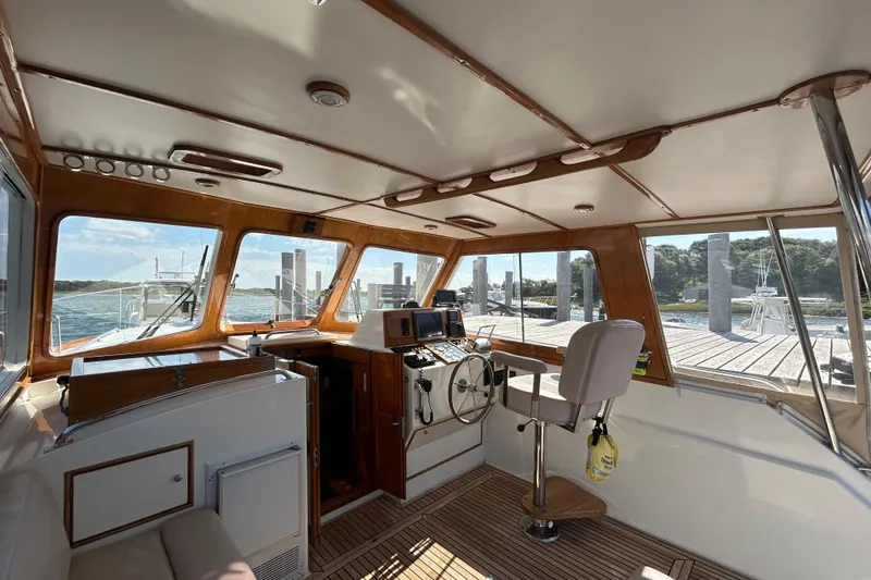 Slide: The Image of Interior of a 1999 Eastbay 38 boat with wooden accents and navigational equipment. - 4