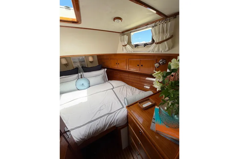 Slide: The Image of Cozy cabin interior of 1999 Grand Banks 38 Eastbay HX with elegant wood finish. - 40
