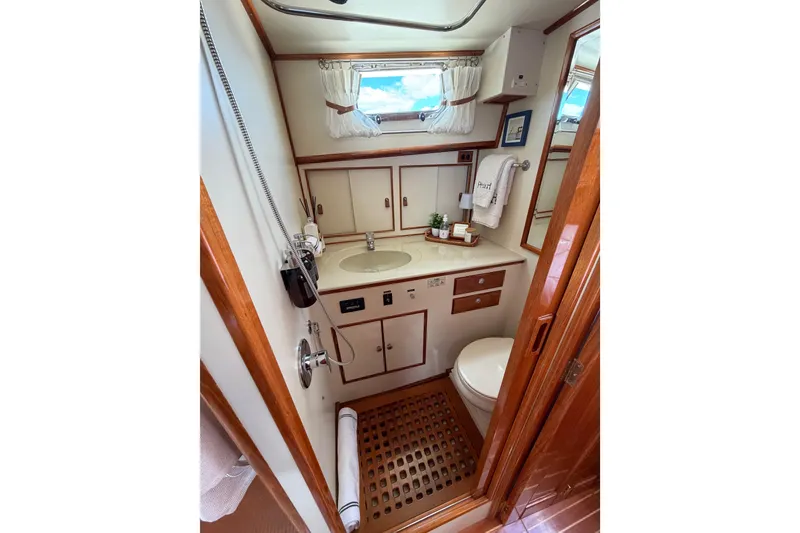 Slide: The Image of Luxurious 1999 Grand Banks 38 Eastbay HX yacht bathroom with elegant wood accents. - 41