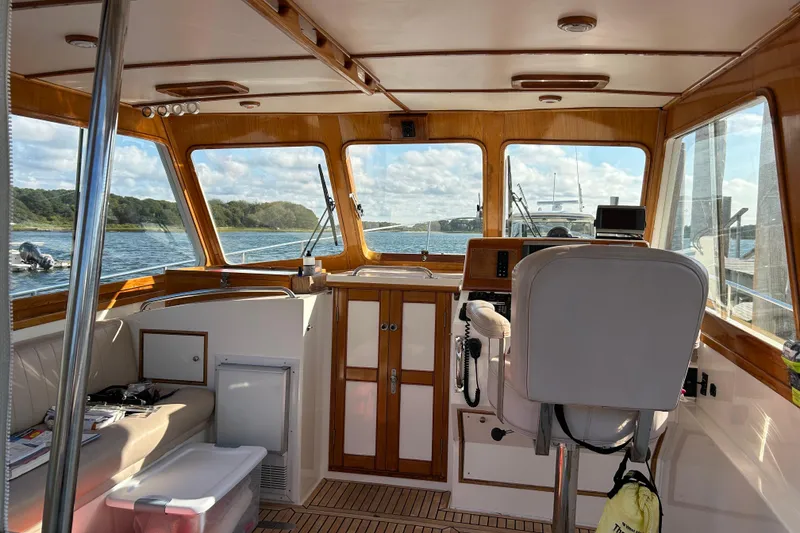 Slide: The Image of Interior of a 1999 Eastbay 38 boat with wooden accents and scenic water view. - 5