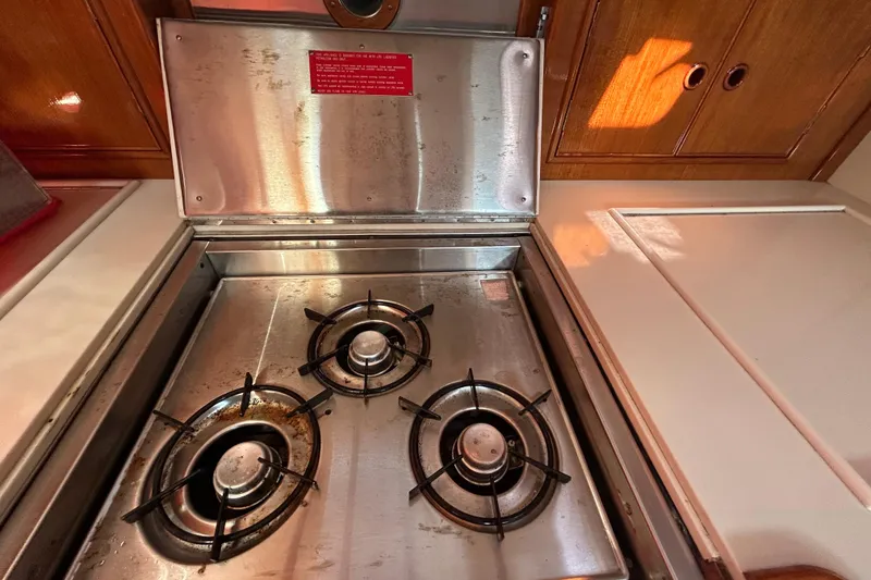 Slide: The Image of Stainless steel three-burner stove in a 1999 Eastbay 38 yacht kitchen. - 8