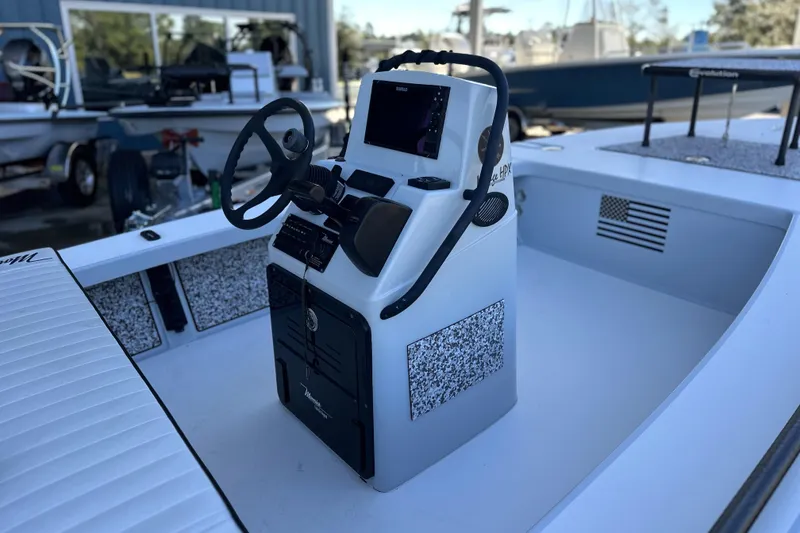 Slide: The Image of 2021 Maverick 18 HPX-V boat interior with steering console and navigation equipment. - 13