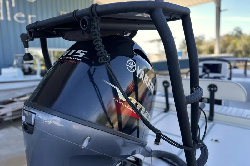 Slide: The Image of 2021 Maverick 18 HPX-V with Yamaha 115 outboard motor, docked outdoors. - 15