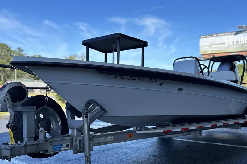 Slide: The Image of 2021 Maverick 18 HPX-V boat on trailer, side view under clear blue sky. - 5