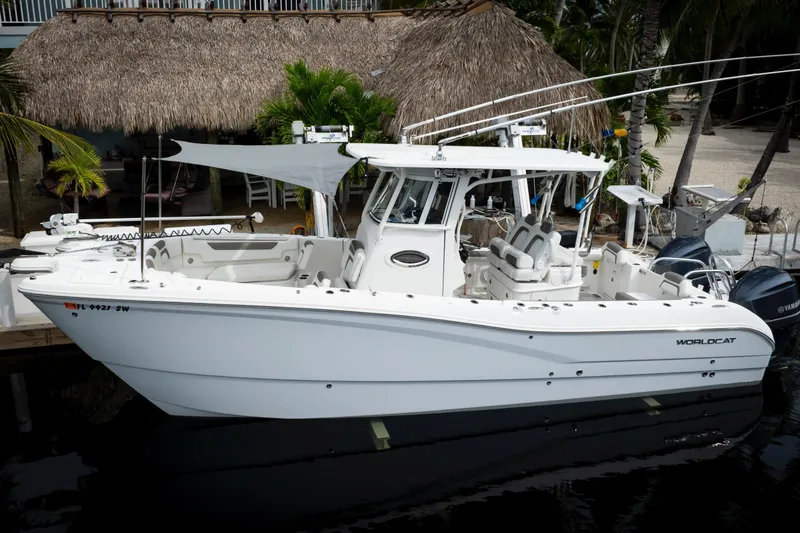The Image of 2021 World Cat 295 CC boat docked, featuring sleek design and dual engines. - 0