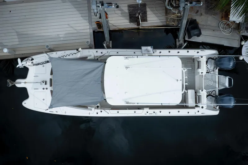 Slide: The Image of Aerial view of 2021 World Cat 295 CC boat docked, featuring dual engines and covered deck. - 10