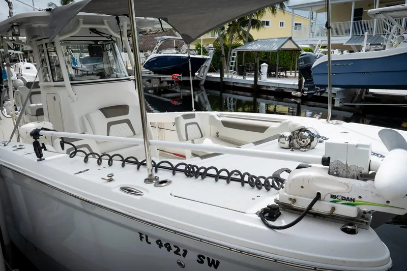 Slide: The Image of 2021 World Cat 295 CC boat docked, featuring spacious deck and modern equipment. - 11