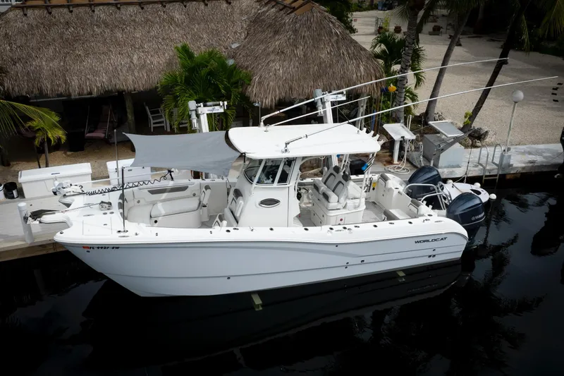 Slide: The Image of 2021 World Cat 295 CC boat docked, featuring dual engines and spacious seating. - 12