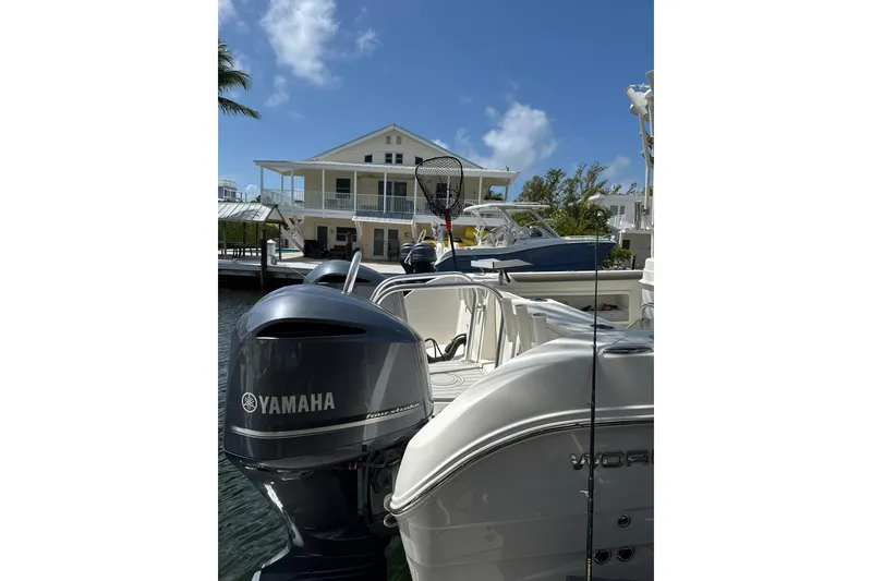 Slide: The Image of 2019 World Cat 295 CC boat with Yamaha engine docked near waterfront house. - 15