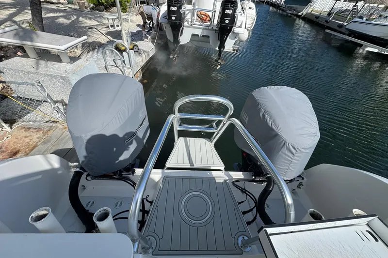 Slide: The Image of 2019 World Cat 295 CC boat with covered engines docked at marina. - 17