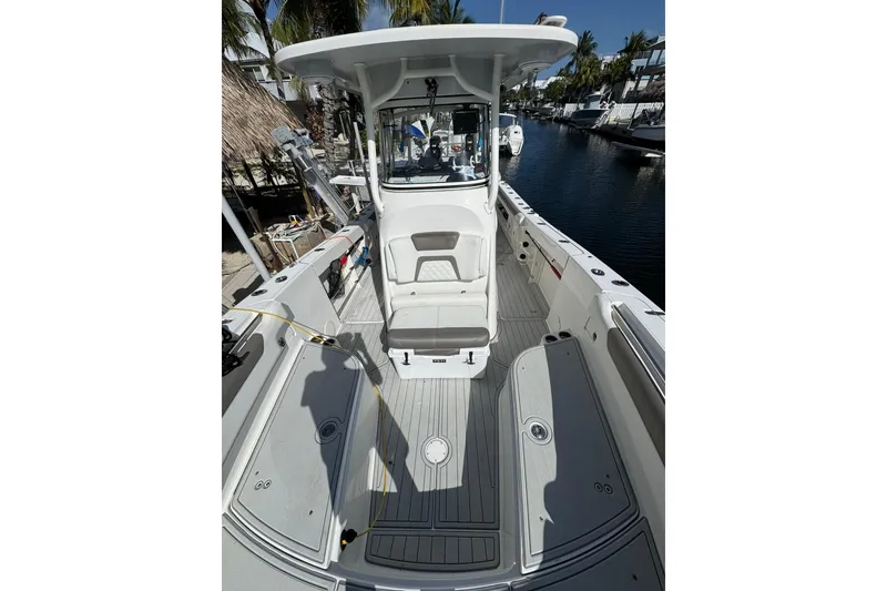 Slide: The Image of 2019 World Cat 295 CC boat interior with spacious deck and modern helm. - 19