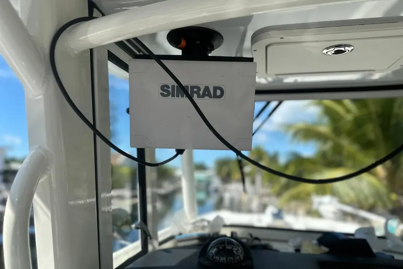 Slide: The Image of Simrad navigation system on 2021 World Cat 295 CC boat, with tropical background. - 22