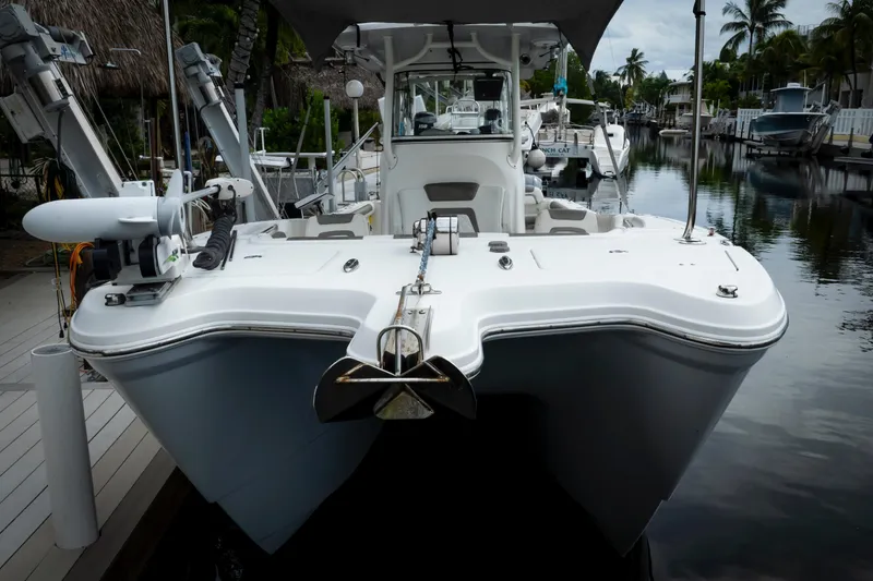 Slide: The Image of 2021 World Cat 295 CC boat docked in a serene canal setting. - 6