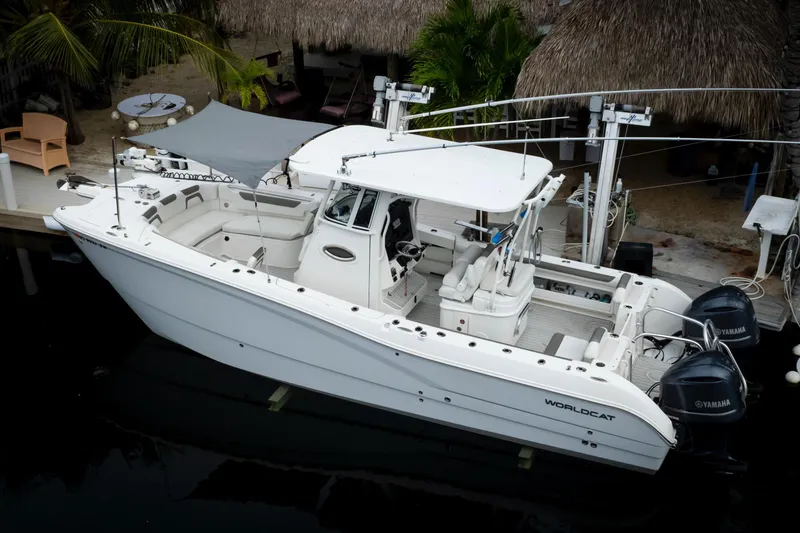 Slide: The Image of 2021 World Cat 295 CC boat docked, featuring dual Yamaha engines and spacious seating. - 8