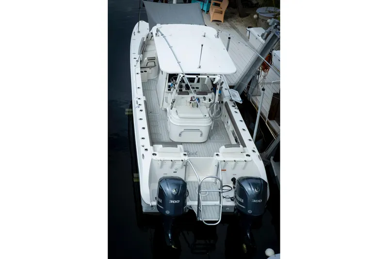 Slide: The Image of 2021 World Cat 295 CC boat with dual Yamaha 300 engines, docked. - 9