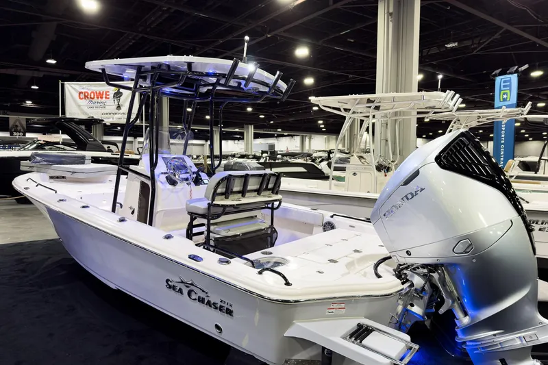 The Image of 2026 Sea Chaser 23 LX boat with Honda engine displayed at indoor boat show. - 0