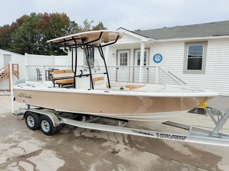 Slide: The Image of 2026 Sea Chaser 23 LX boat showcased at an indoor exhibition, featuring a powerful engine. - 1