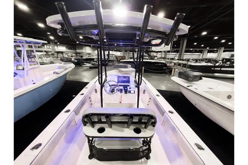 Slide: The Image of 2026 Sea Chaser 23 LX boat interior at a boat show, featuring modern controls and seating. - 10