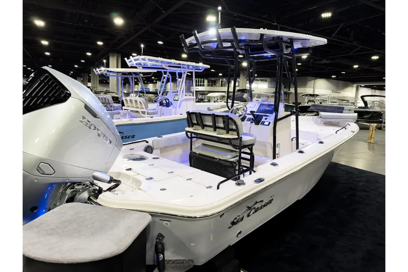 Slide: The Image of 2026 Sea Chaser 23 LX boat displayed at an indoor exhibition, featuring a Honda engine. - 2