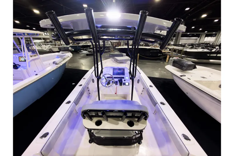 Slide: The Image of 2026 Sea Chaser 23 LX boat interior at a boat show, featuring modern controls and seating. - 3