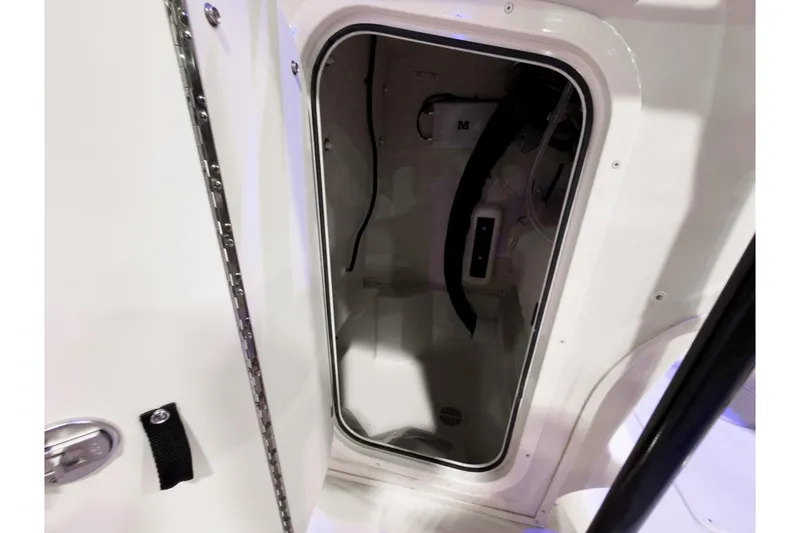 Slide: The Image of 2026 Sea Chaser 23 LX boat interior compartment with open door. - 6