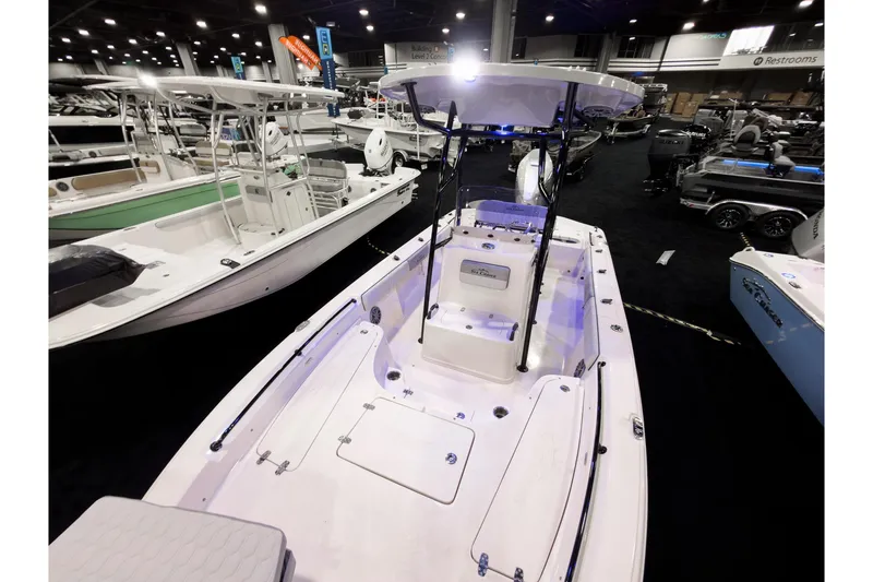 Slide: The Image of 2026 Sea Chaser 23 LX boat displayed at an indoor boat show. - 7