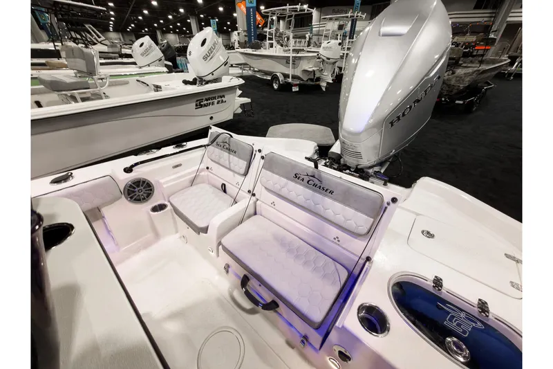 Slide: The Image of 2026 Sea Chaser 23 LX boat interior with Honda engine at a boat show. - 9