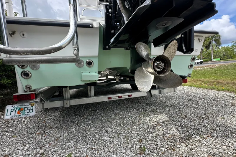 Slide: The Image of 2020 Shallow Sport 24 Classic boat on trailer, showing propeller and Florida license plate. - 11